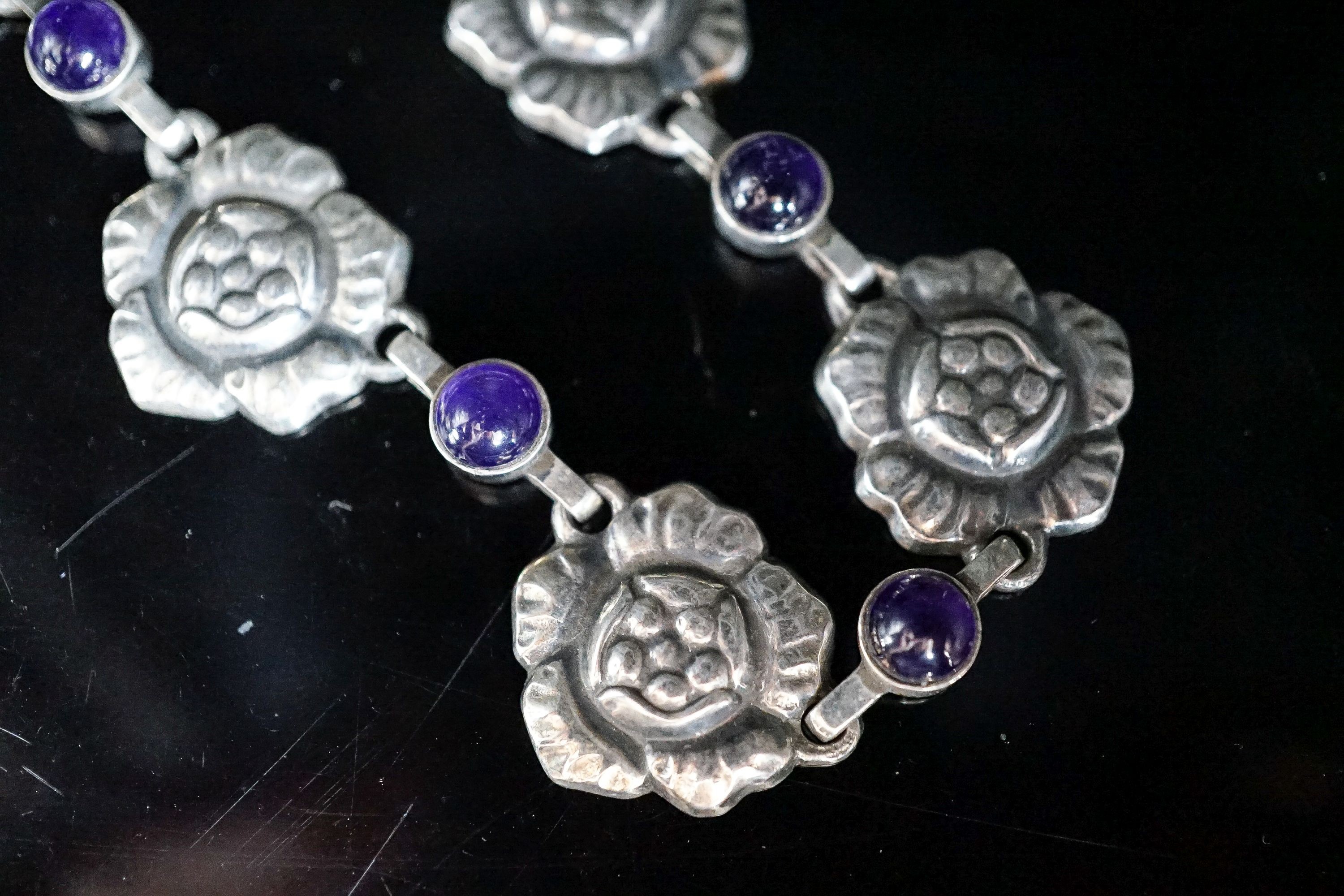 A Georg Jensen sterling flower head and cabochon amethyst link necklace, set with twelve stones. no. 5, approx. 42cm.